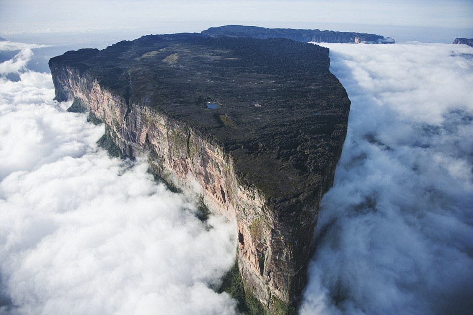 Mount Roraima is the highest tepui reaching 2810 meters in elevation. These cloud covered flat top mountains are considered to be some of the oldest geological formations on Earth. --- Image by © Martin Harvey/Corbis